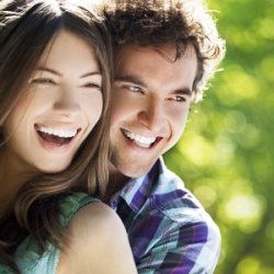 A young happy couple hugging and laughing.