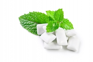 Chewing gum and fresh mint leaves, isolated on white