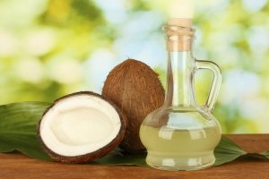 decanter with coconut oil and coconuts on green backgrounddecanter with coconut oil and coconuts isolated on whitecoconut oil in bottles with coconuts on white backgroundcoconut oil in bottles with coconuts on green background