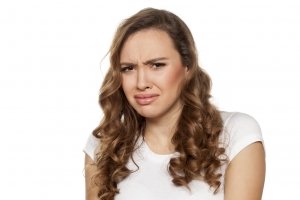 pretty disgusted girl on a white background