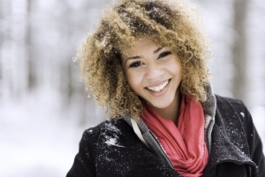 Portrait of young woman smiling in the winter,grain added